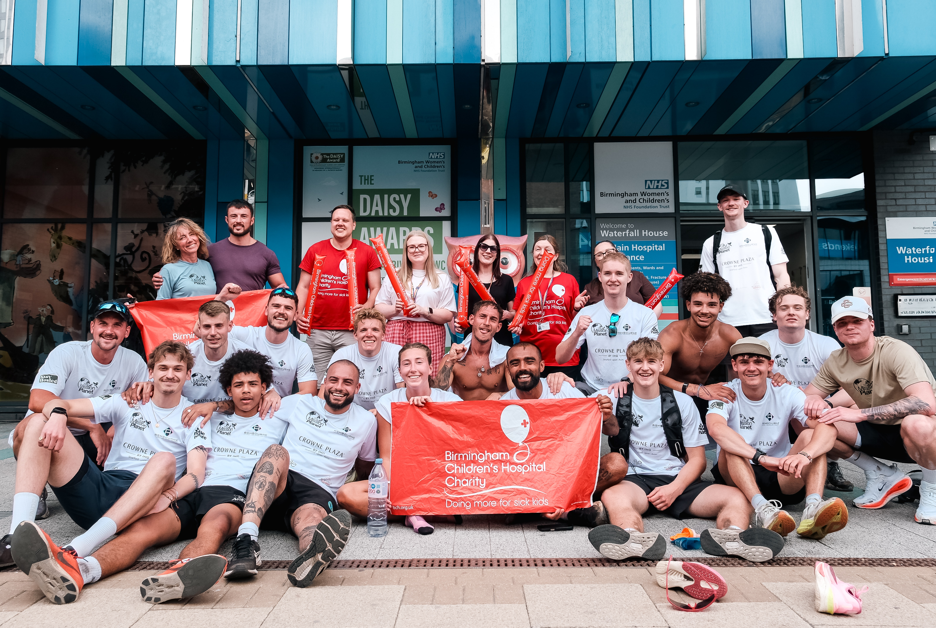 The team together outside Birmingham Children's Hospital with the charity flag