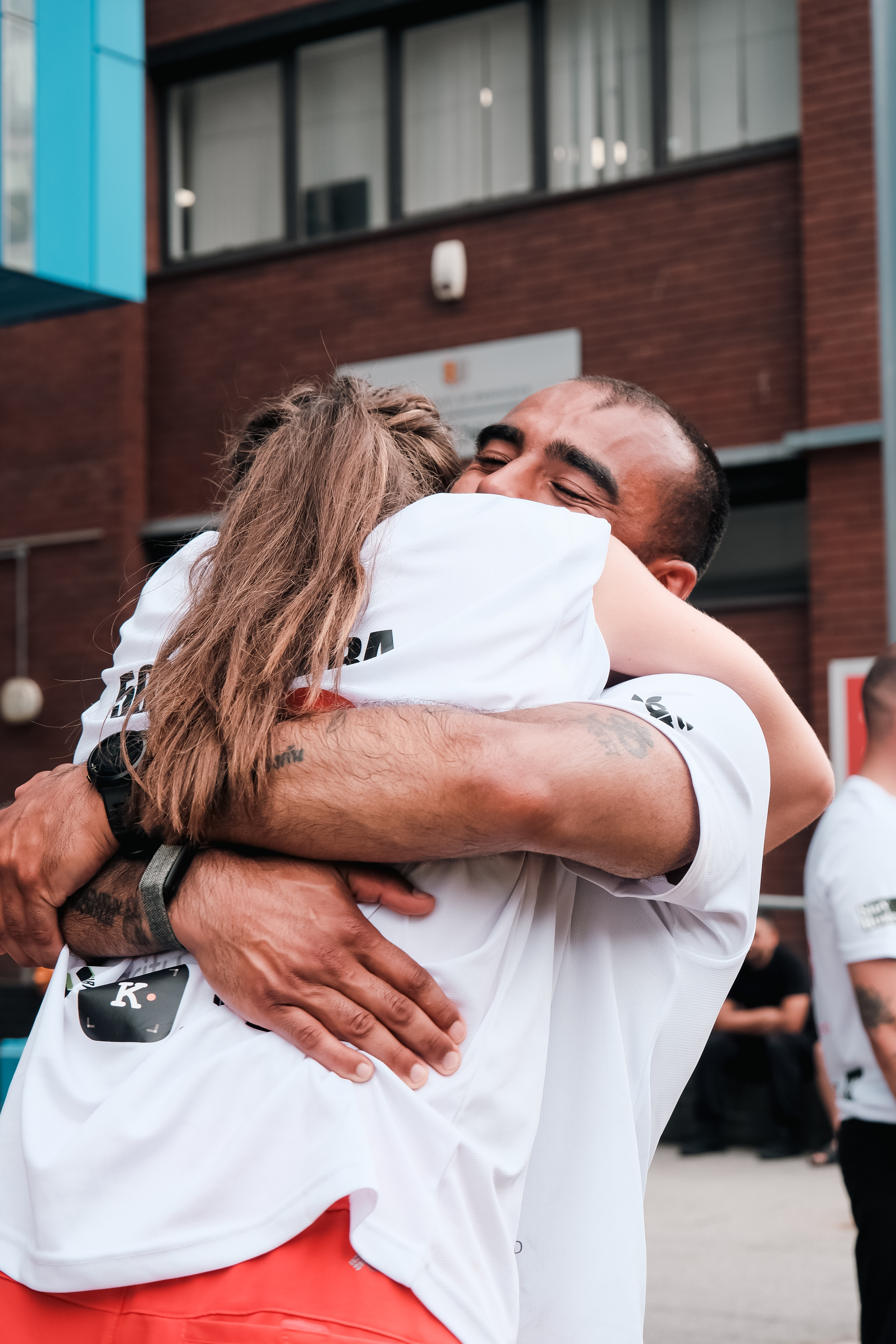 Two of the team share an emotional hug at the hospital