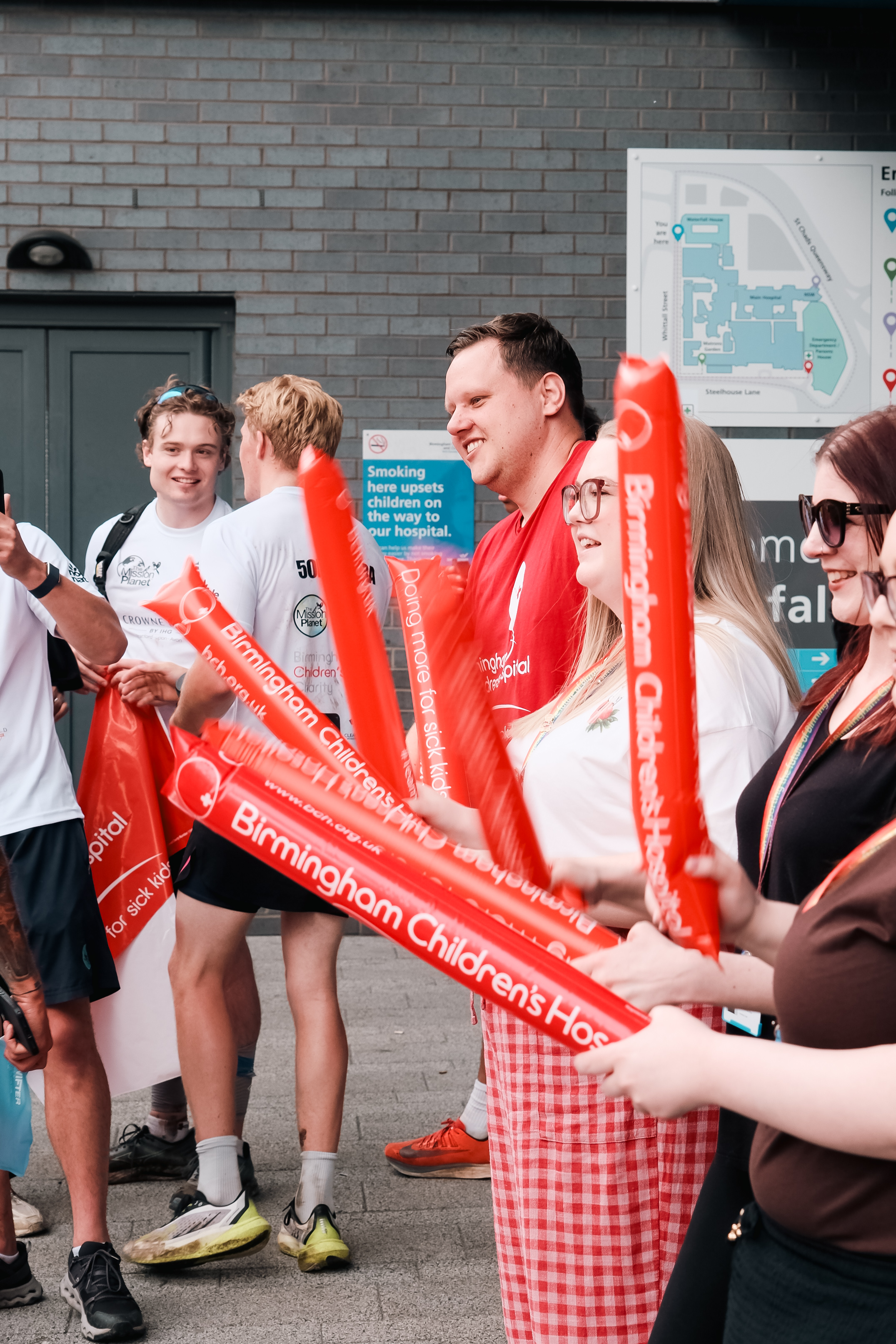 The hospital team welcome the runners with cheer sticks